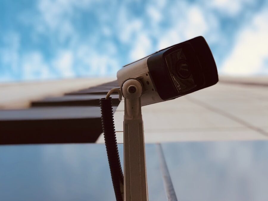 A video camera sitting on top of a table next to a pool